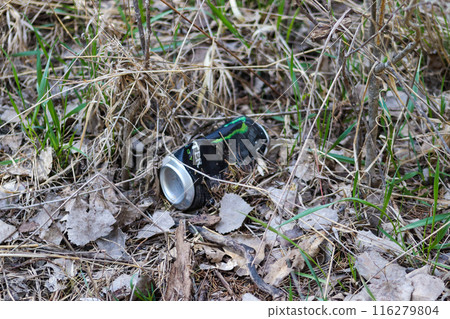 a soda can left out in the dirt at the park  116279804