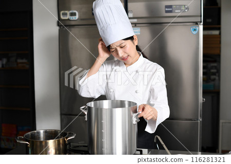 Asian female chef worried in front of a cooking pot Asian female chef worried in front of a cooking pot 116281321