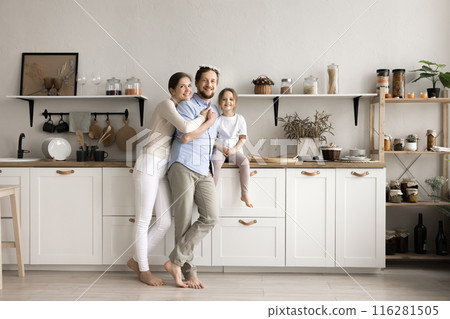 Happy family with kid posing in modern renovated kitchen Happy family with kid posing in modern renovated kitchen 116281505