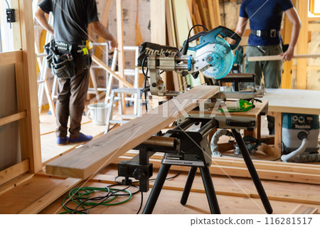 Carpenter working at a construction site of a new house 116281517