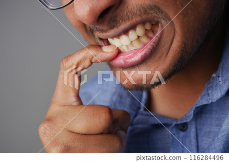 young men biting his nails at home, young men biting his nails at home, 116284496