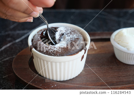 Delicious Chocolate Lava Cake with Powdered Sugar and Whipped Cream on Wooden Plate 116284543