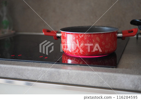 cooking pan on electric stove, electric stove is heated to red. cooking pan on electric stove, electric stove is heated to red. 116284595