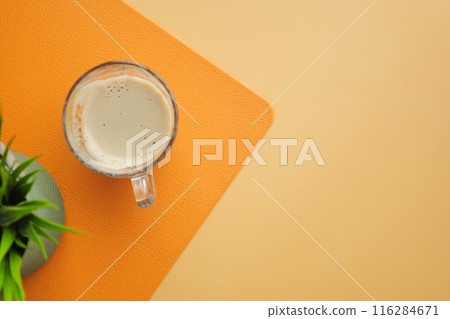 Coffee mug, plant, orange and beige background for cozy and warmtoned home decor Coffee mug, plant, orange and beige background for cozy and warmtoned home decor 116284671