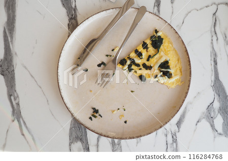 An empty dirty plate with a fork. 116284768