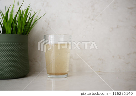 dirty glass of water on a table  116285140