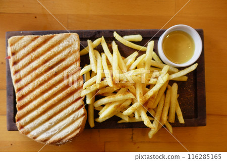sandwich or toast with toasted bread slices served with french fries sandwich or toast with toasted bread slices served with french fries 116285165