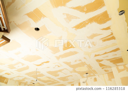 The ceiling of a used house undergoing renovation with the wallpaper removed The ceiling of a used house undergoing renovation with the wallpaper removed 116285318