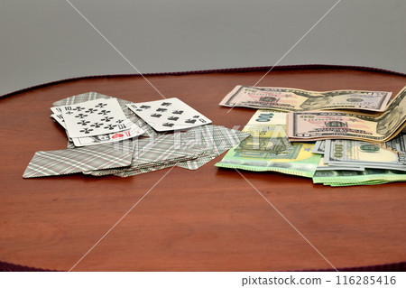 Money and cards are on the table. 116285416