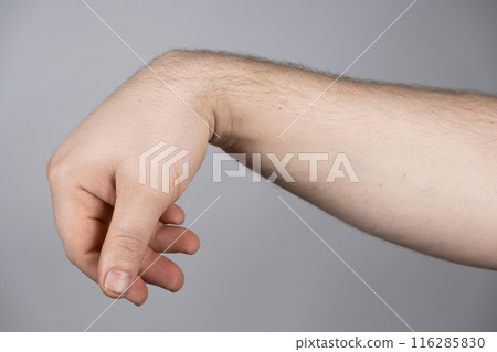 Ganglion cyst or hygroma of the wrist on the hand of a male patient 116285830