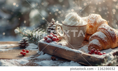 On a snow-covered wooden table, a cup of aromatic coffee with cream, hot croissants, cranberries, fir cones 116286032