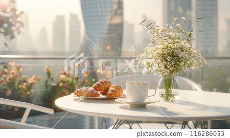 Summer breakfast on the terrace, aromatic coffee and fresh croissants on a marble table 116286053