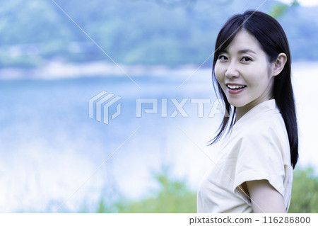 A woman sightseeing at the waterfront A woman sightseeing at the waterfront 116286800