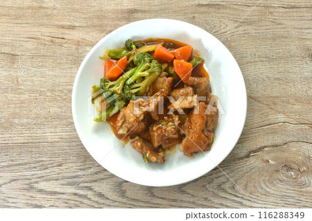 fried pork bone with steamed broccoli and carrot dressing sweet red gravy sauce on plate fried pork bone with steamed broccoli and carrot dressing sweet red gravy sauce on plate 116288349