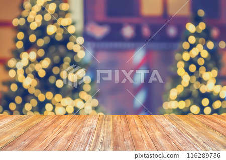 Empty wood table top with blur Christmas tree with bokeh light background Empty wood table top with blur Christmas tree with bokeh light background 116289786
