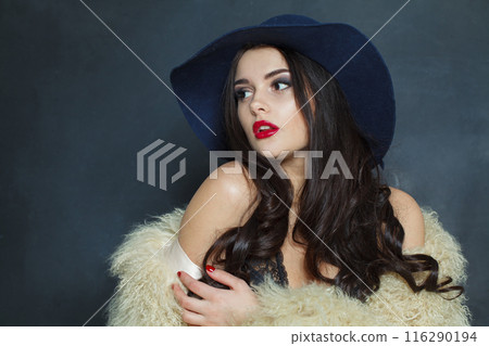 Sensual fashion model woman with long dark wavy hairstyle and red lips make-up Sensual fashion model woman with long dark wavy hairstyle and red lips make-up 116290194