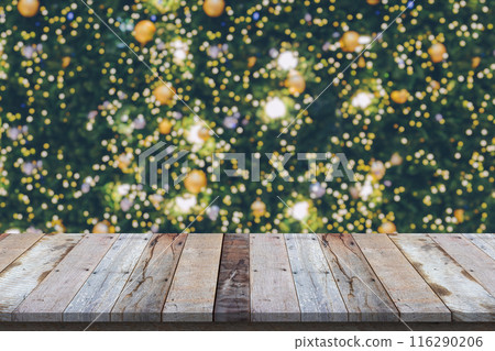 Empty wood table top with blur Christmas tree with bokeh light background Empty wood table top with blur Christmas tree with bokeh light background 116290206