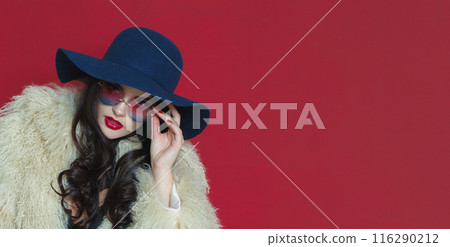 Close up photo of fashion model woman with long dark wavy hairstyle and red lips make-up Close up photo of fashion model woman with long dark wavy hairstyle and red lips make-up 116290212