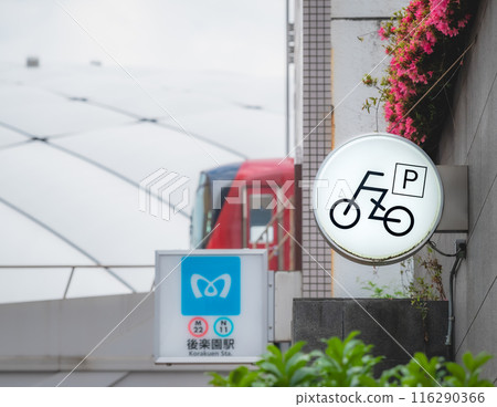 A bicycle parking lot sign installed near the station A bicycle parking lot sign installed near the station 116290366