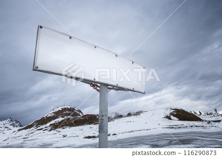 Amidst the peaceful winter setting, an abandoned billboard stands, bare and deserted Amidst the peaceful winter setting, an abandoned billboard stands, bare and deserted 116290873