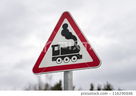 Train Crossing Sign with Vintage Locomotive illustrates caution and transportation safety Train Crossing Sign with Vintage Locomotive illustrates caution and transportation safety 116290886