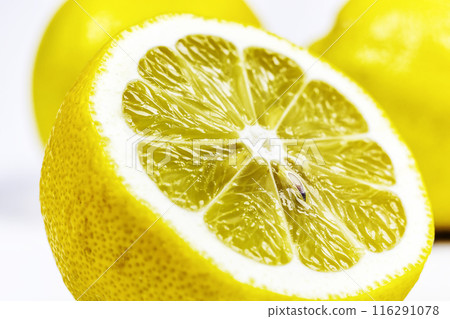 Half of a cut lemon close-up on a white background. On a white background a cut half of a lemon close-up Half of a cut lemon close-up on a white background. On a white background a cut half of a lemon close-up 116291078