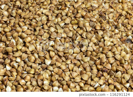 Close-up of buckwheat seeds in full frame. Seeds of buckwheat groats in the whole frame close up 116291124