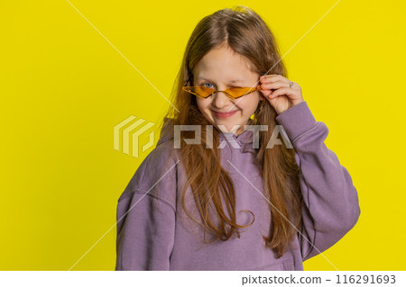 Child girl kid wearing orange sunglasses blinking eye, looking at camera with smile winking flirting Child girl kid wearing orange sunglasses blinking eye, looking at camera with smile winking flirting 116291693