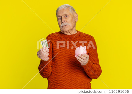 Poor senior old man insufficient amount of money, holding piggybank and one dollar banknote crisis Poor senior old man insufficient amount of money, holding piggybank and one dollar banknote crisis 116291696
