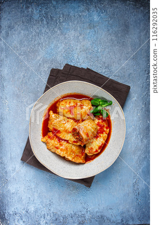 Stuffed cabbage rolls with minced meat, in tomato sauce, top view, without people, in the spotlight. 116292035