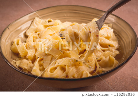 Fettuccine, tagliatelle, in creamy garlic sauce, Italian traditional cuisine, pasta carbonaro, 116292036