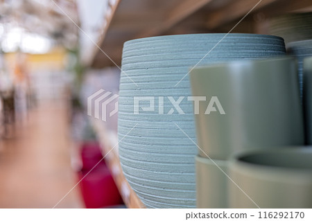 Selective focus various colorful flower pots on a shelf in gardening store Selective focus various colorful flower pots on a shelf in gardening store 116292170