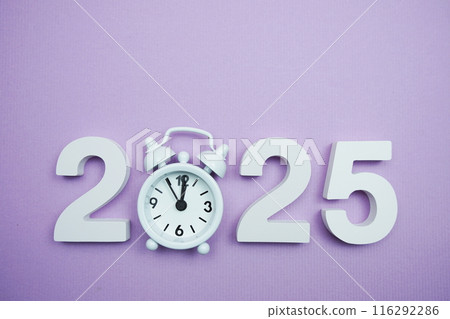 Happy New Year 2025 with alarm clock on purple background Happy New Year 2025 with alarm clock on purple background 116292286