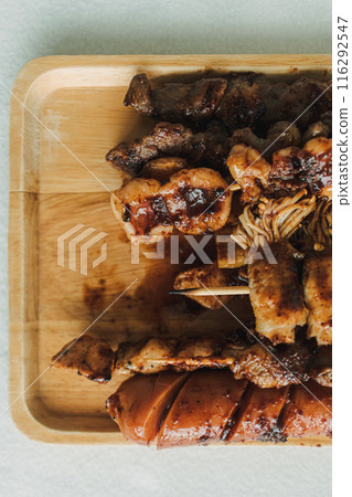 Mala skewers served on the wooden plate. Mala skewers served on the wooden plate. 116292547