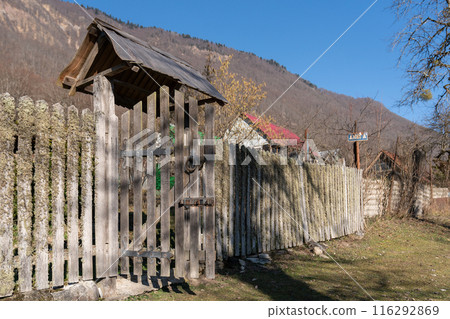Old fence in a high mountain village in Russia. 116292869