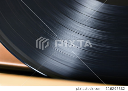Old LP vinyl in old player closeup 116292882