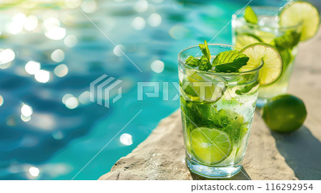 Glasses of mojito with lime and mint. on the edge of a swimming pool in a hotel 116292954