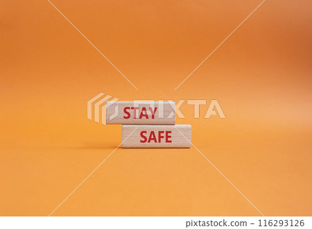 Stay Safe symbol. Concept word Stay Safe on wooden blocks. Beautiful orange background. Business and Stay Safe concept. Copy space 116293126