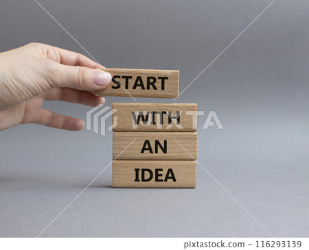 Start with an Idea symbol. Wooden blocks with words Start with an Idea. Beautiful grey background. Businessman hand. Business and Start with an Idea concept. Copy space. 116293139
