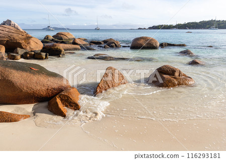 Anse Lazio beach view, wet rocks and shore water on a sunny summer day 116293181