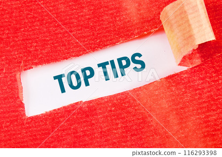 The phrase Top Tips on a white background under torn paper The phrase Top Tips on a white background under torn paper 116293398