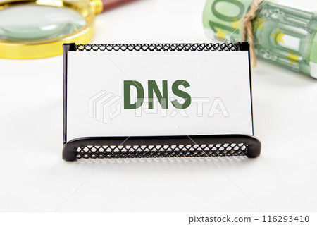 DNS Domain Name Server. Business and DNS concept. Copy space. DNS written on a business card in a composition with Euro banknotes and a magnifying glass out of focus DNS Domain Name Server. Business and DNS concept. Copy space. DNS written on a business card in a composition with Euro banknotes and a magnifying glass out of focus 116293410