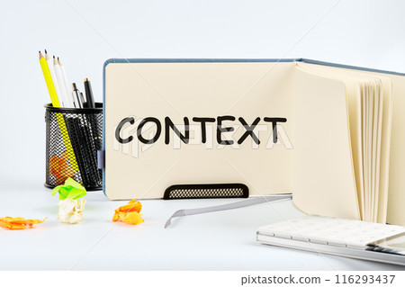 Conceptual context symbol. Copy space. Context word written in a notebook on a table on a light background Conceptual context symbol. Copy space. Context word written in a notebook on a table on a light background 116293437