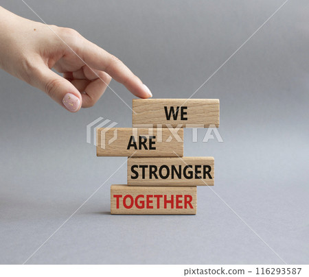 We are stronger together symbol. Wooden blocks with words We are stronger together. Businessman hand. Beautiful grey background. We are stronger together concept. Copy space. We are stronger together symbol. Wooden blocks with words We are stronger together. Businessman hand. Beautiful grey background. We are stronger together concept. Copy space. 116293587