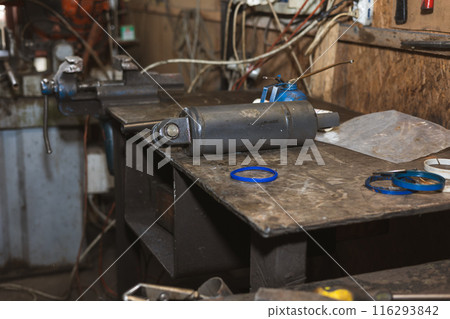 Spare parts from a tractor. Repair shop. 116293842