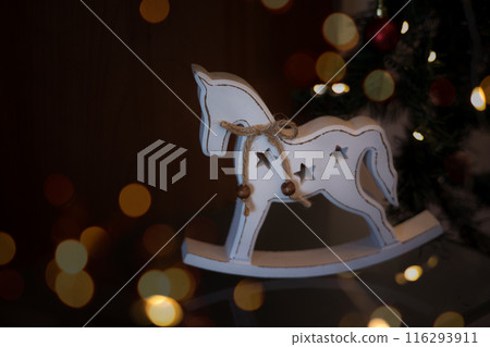 Christmas decoration white horse on a dark background con bokeh and copy space for text. Christmas decoration white horse on a dark background con bokeh and copy space for text. 116293911