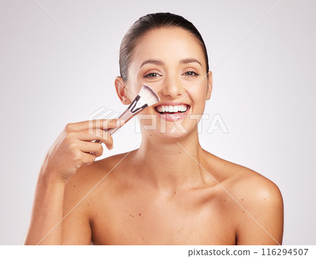 Woman, brush and foundation in studio portrait, makeover and makeup routine on white background. Female person, cosmetics tool and highlight or contour powder, skincare and facial treatment for glow 116294507