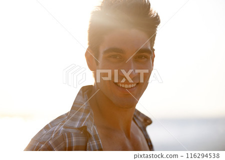 Happy, beach and portrait of man in summer for vacation, holiday and weekend outdoors. Nature, travel and face of person with smile for relaxing, adventure and sunshine by ocean on tropical island Happy, beach and portrait of man in summer for vacation, holiday and weekend outdoors. Nature, travel and face of person with smile for relaxing, adventure and sunshine by ocean on tropical island 116294538