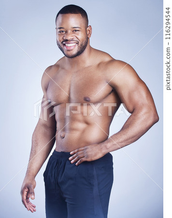 Fitness, portrait and happy black man in studio with body pride, confidence and training results on grey background. Sports, face and African male model with muscle growth, sixpack or abs progress 116294544