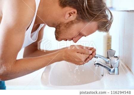 Water splash, cleaning and man in bathroom for washing face, hygiene or morning routine at sink. Wet, wellness and male person by faucet for grooming, self care or natural facial treatment in home Water splash, cleaning and man in bathroom for washing face, hygiene or morning routine at sink. Wet, wellness and male person by faucet for grooming, self care or natural facial treatment in home 116294548